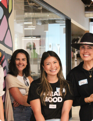 A group of people smiling shown.