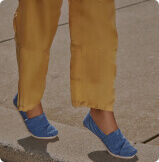 Feet view of model wearing TOMS Blue Micro Cord Alpargatas.